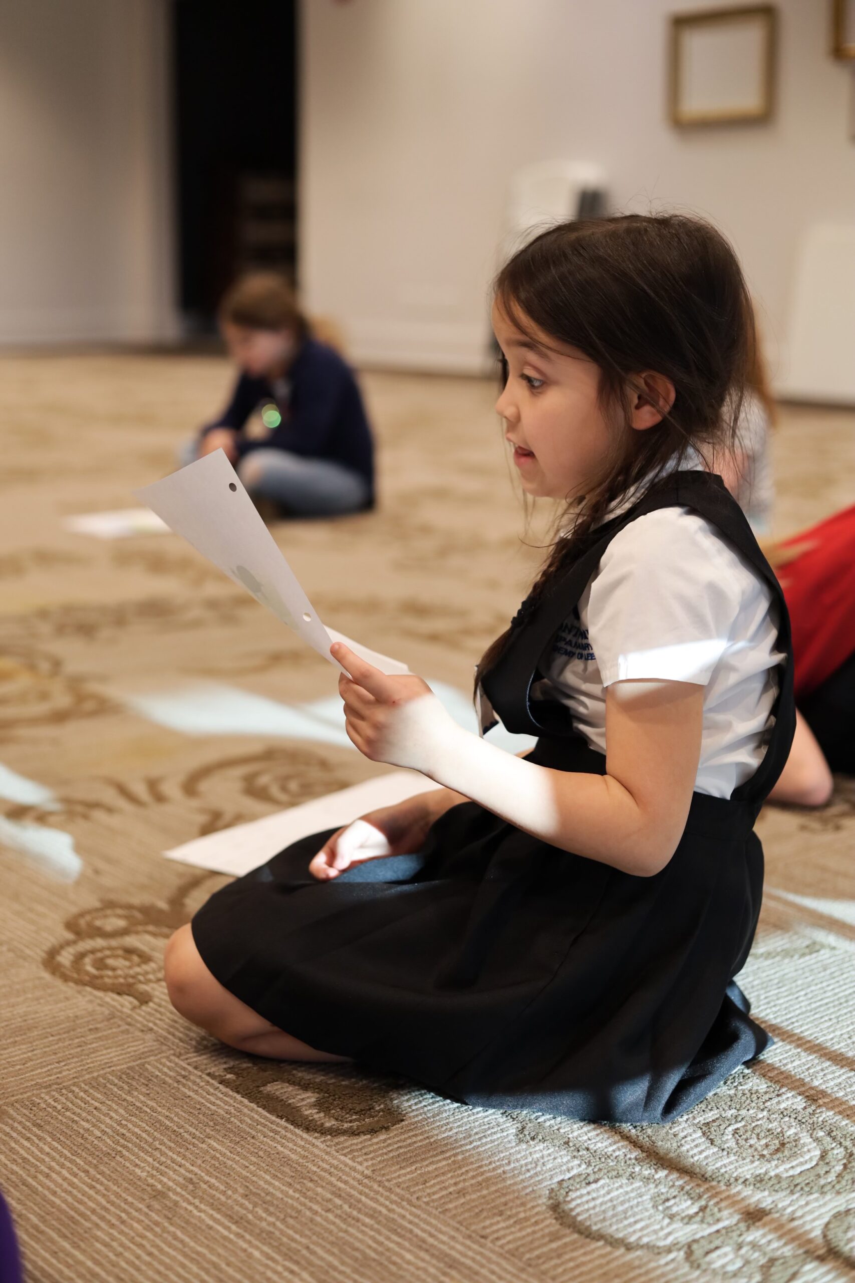 Girl reads stage instructions at theater camp